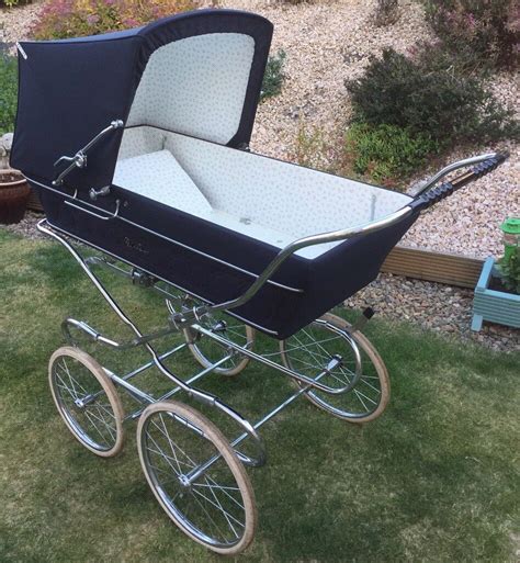 old fashioned silver cross pram.